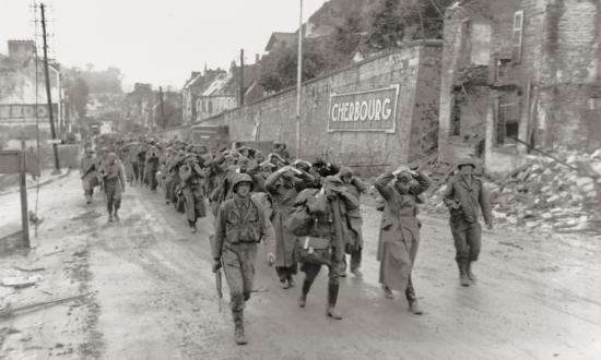 U.S. soldiers march German prisoners of war through Cherbourg on 28 June 1944